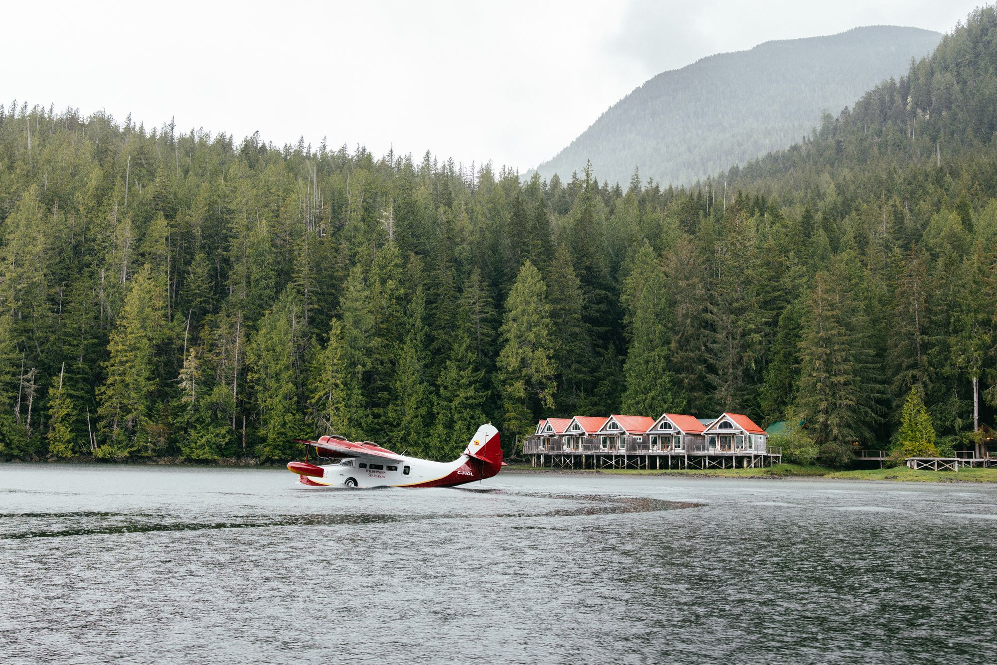 Floatplane landing in front of the cabins of Nimmo Bay, Great Bear Rainforest